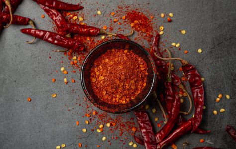 Red chilli paste on a black background.